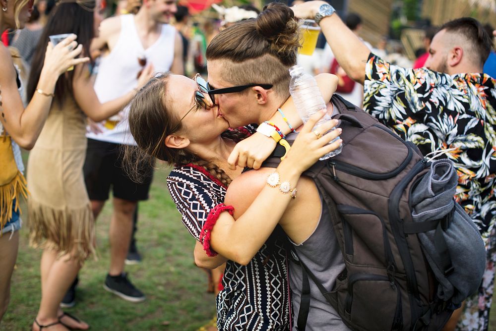 Woman Kissing Man in Live Music Concert Festival
