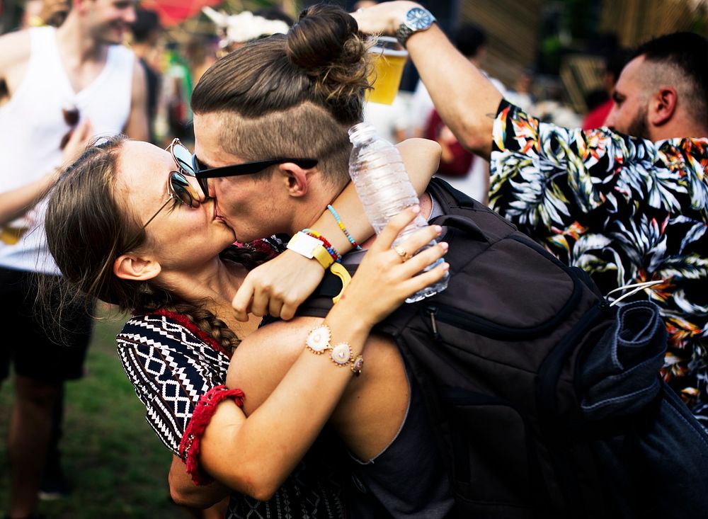 Woman Kissing Man in Live Music Concert Festival