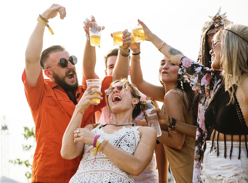 Group of Friends Drinking Beers Enjoying Music Festival Together