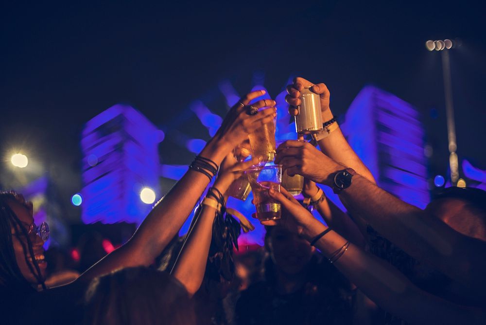 Group of Friends Drinking Beers Enjoying Music Festival together