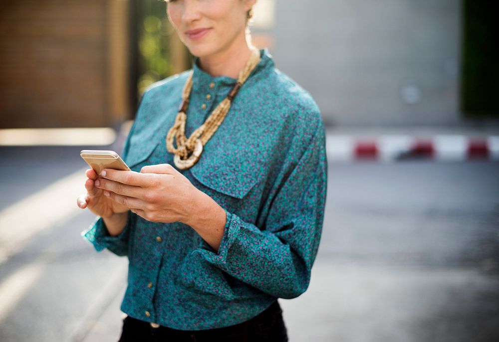 Businesswoman standing and using mobile phone