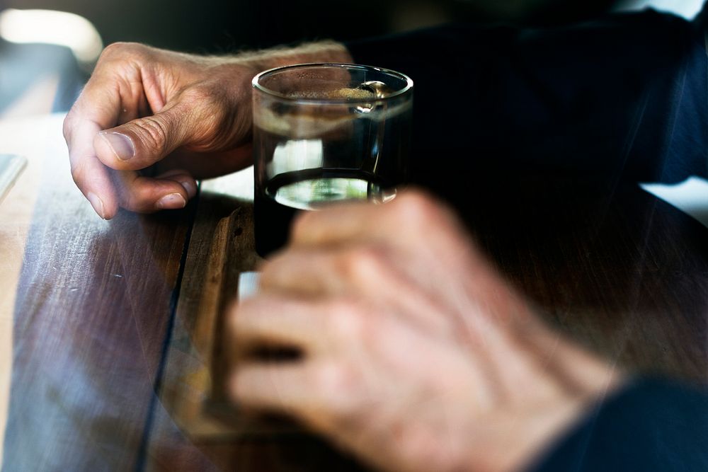 Human hand with a glass of drinks