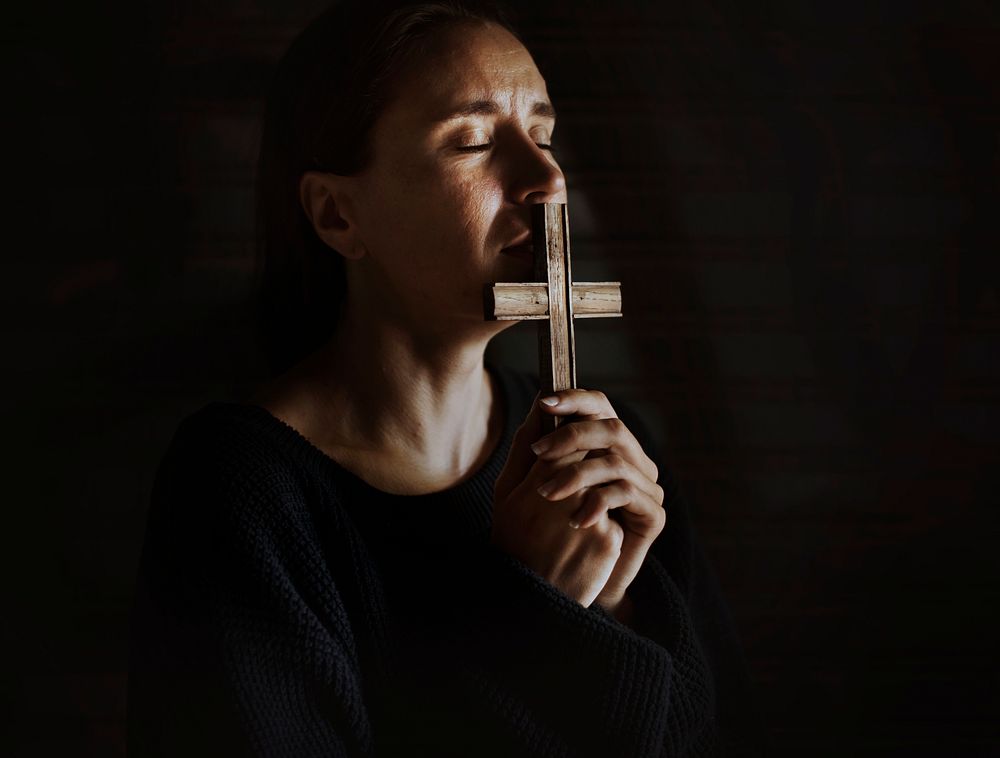 Woman Holding Cross Praying for God