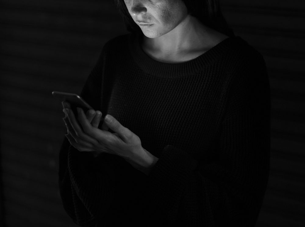 Woman Using Mobile Phone in the Dark