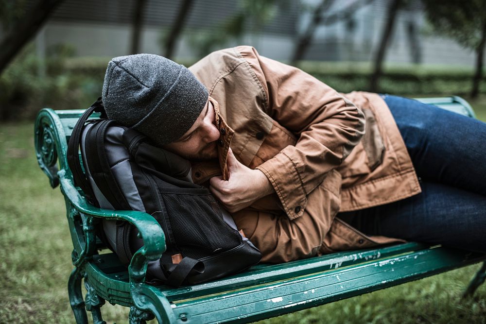Homeless People Sleeping on Bench in The Park