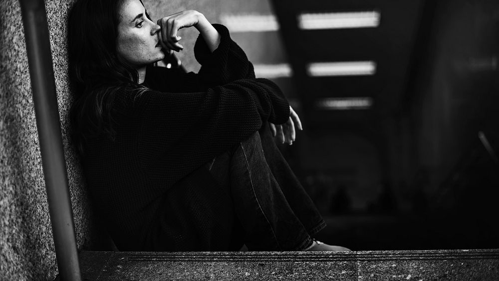 Woman Sitting Look Worried on The Stairway Grayscale