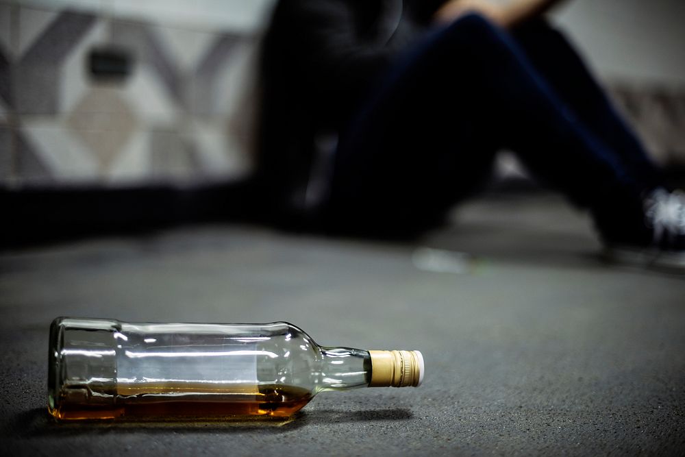 Liquor Alcohol Bottle Lying on The Floor