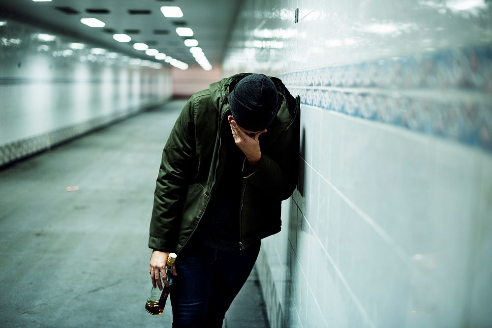 Alcoholic Homeless Holding Liquor Bottle
