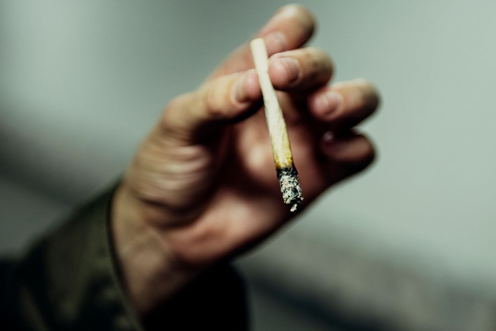 Closeup of hand holding cigarette