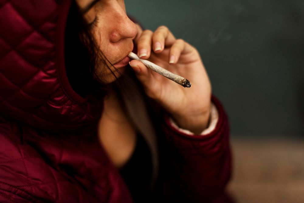 Woman smoking cigarette alone