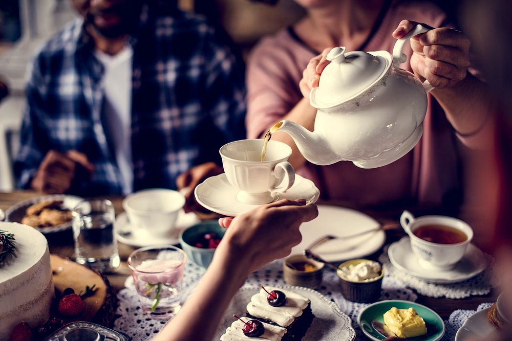 People celebrate birthday party with cake and tea