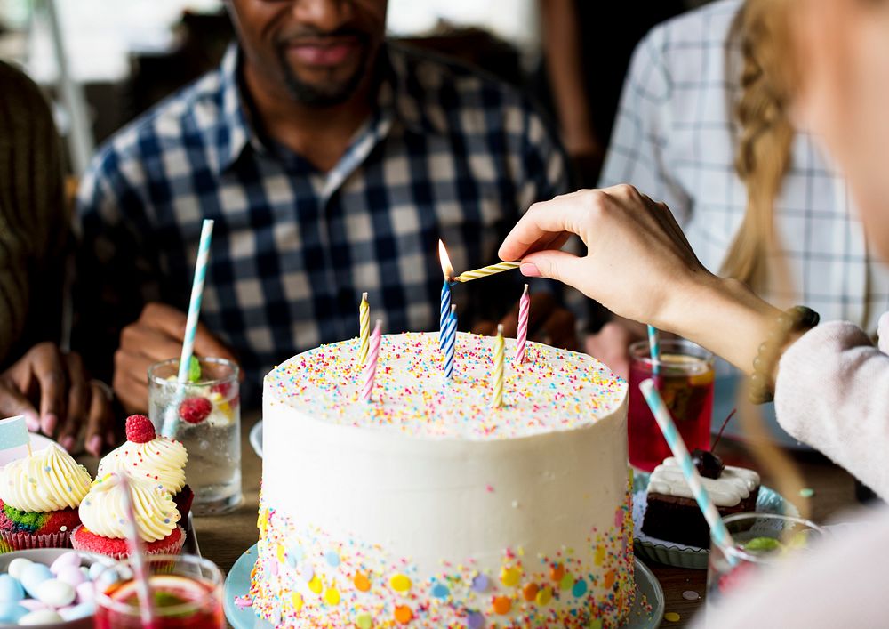 Woman Lighting Up Candles on Cake on Her Birthday Party Celebration