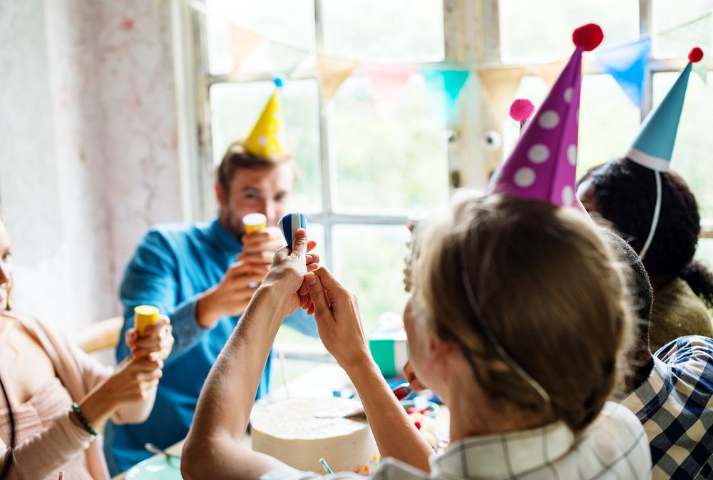 People Using Party Popper at a Birthday Celebration