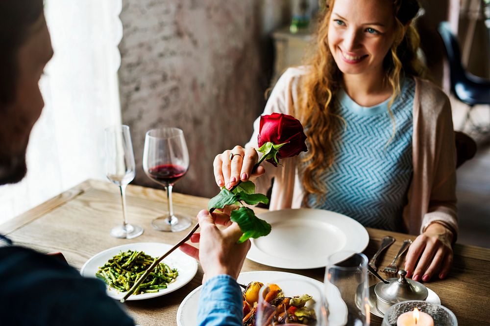 Giving a romantic red rose on a date