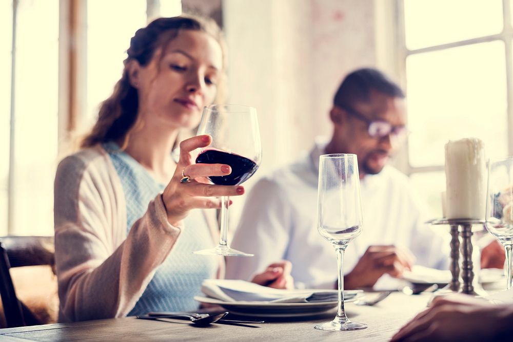 Woman Holding Red Wine Glass in a Classy Restaurant