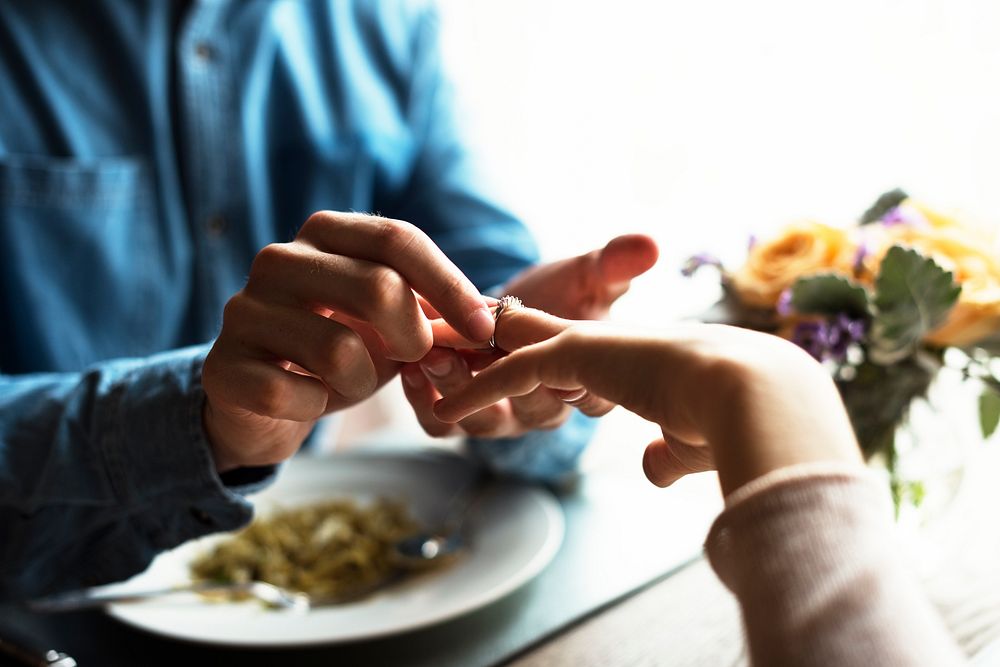 Romantic Man Giving a Ring to Propose Woman on a Date