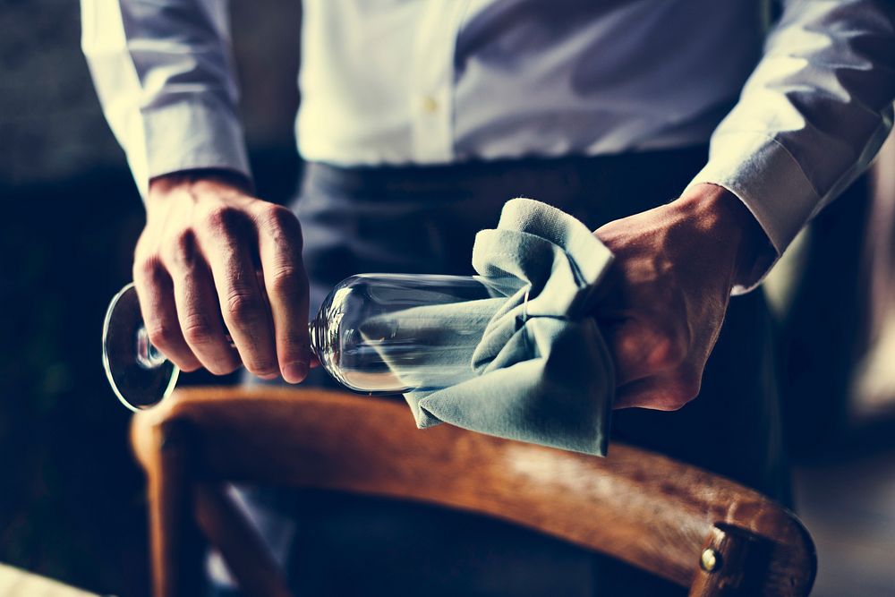 Restaurant Staff Wiping Glass on Table Setting Service for Recep