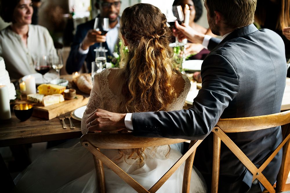 Bride and Groom Having Meal with Friends at a Wedding Reception