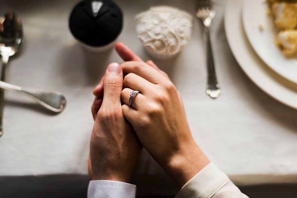Close up of wedding couple hands holding each other