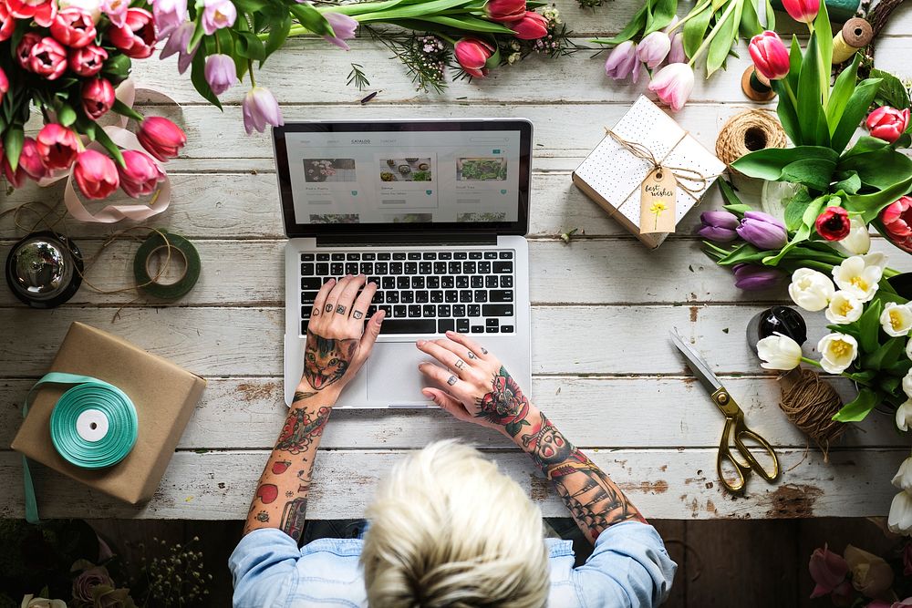 Tattooed person shopping for plants online
