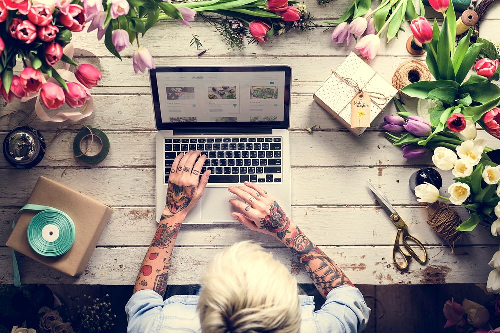 Woman Using Laptop Searching on Internet to Shop Flowers Plants