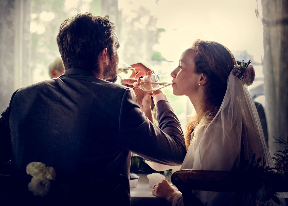 Bride and Groom Drinking Wine Together at Wedding Reception