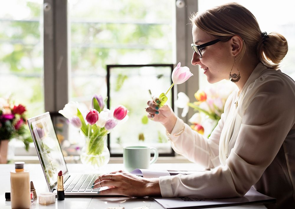 Woman using laptop with flower decorated