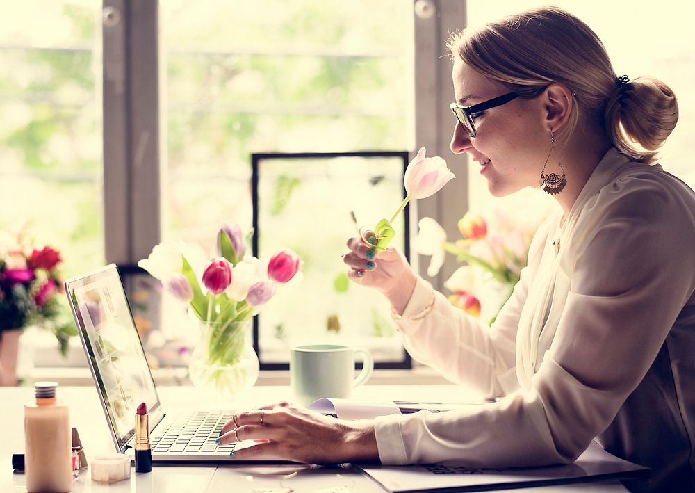 Woman using laptop with flower decorated