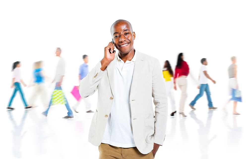 A Cheerful Smart Casual Guy on a Mobile Phone in a Busy Background
