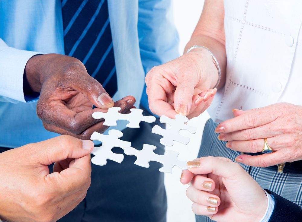 Group of Business People Building Jigsaw