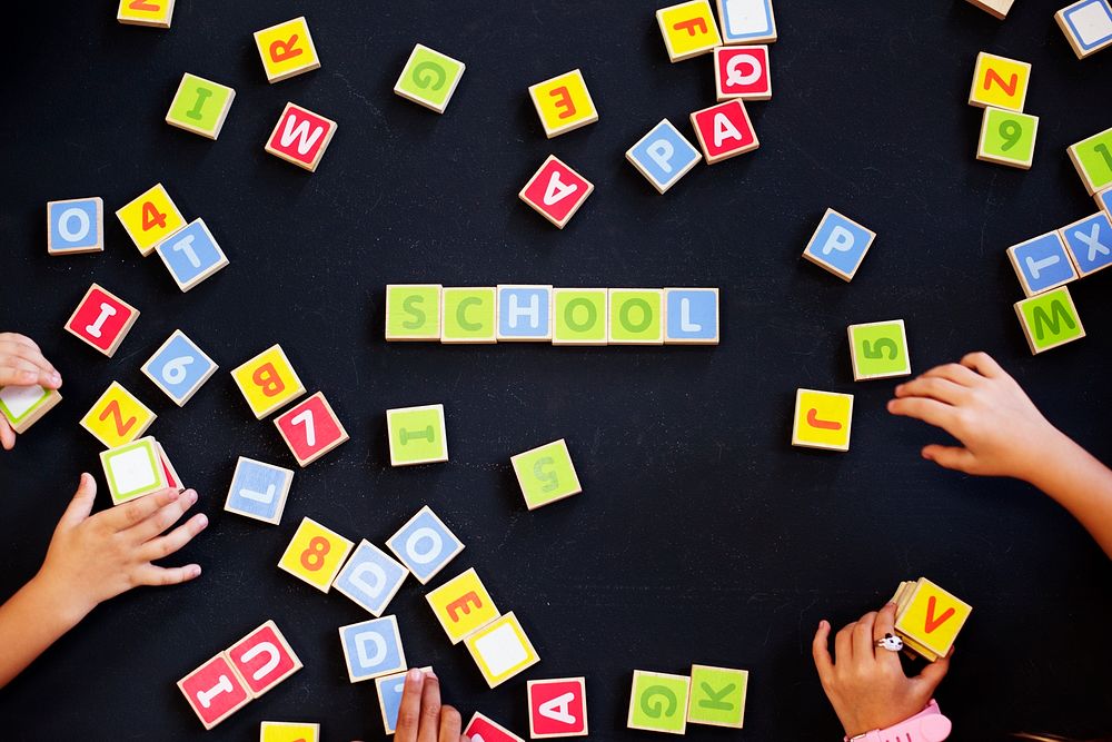 Kids spelling out words with alphabet blocks