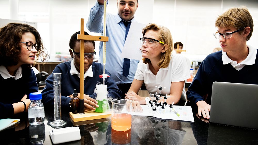 Students doing a science experiment project with a teacher