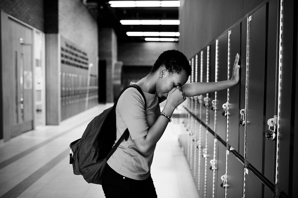Young sad student on the hallway