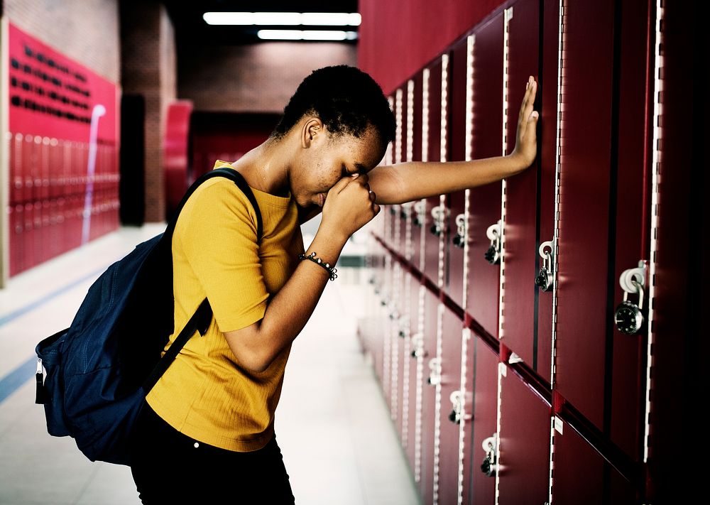 Young sad student on the hallway