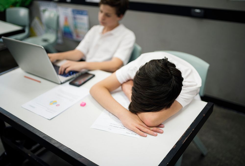 Students studying and napping on a desk 