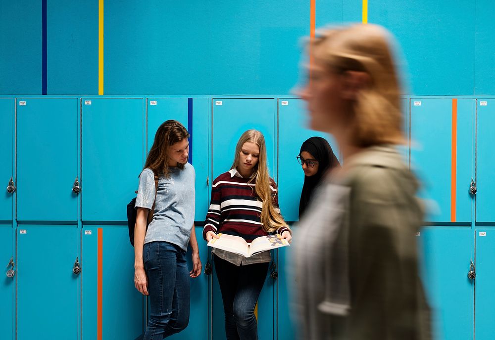 Students talking at the hallway lockers 