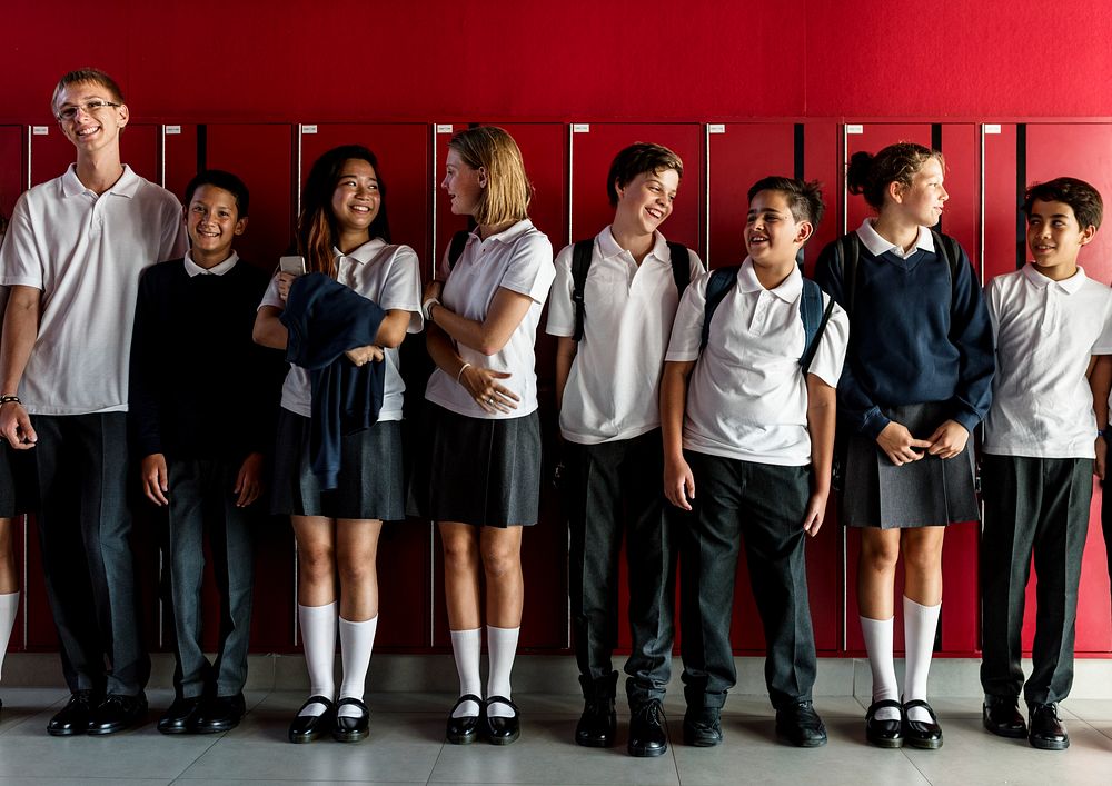Friends standing together in front of lockers