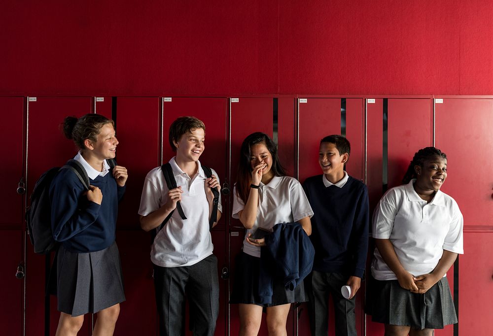 Group of diverse students standing by the locker