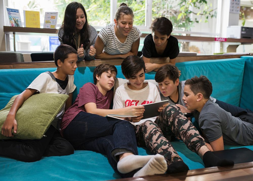 Group of young adult watching using tablet device