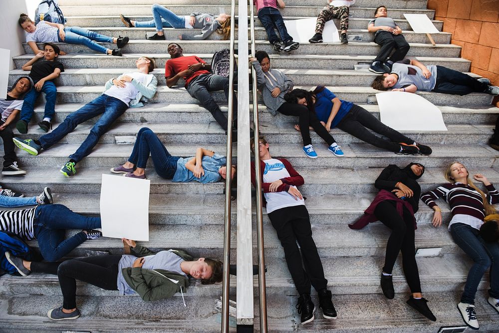 Group of exhausted students sleeping on stairways