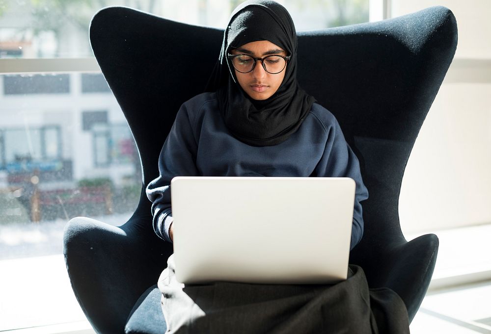 Young muslim woman using computer laptop