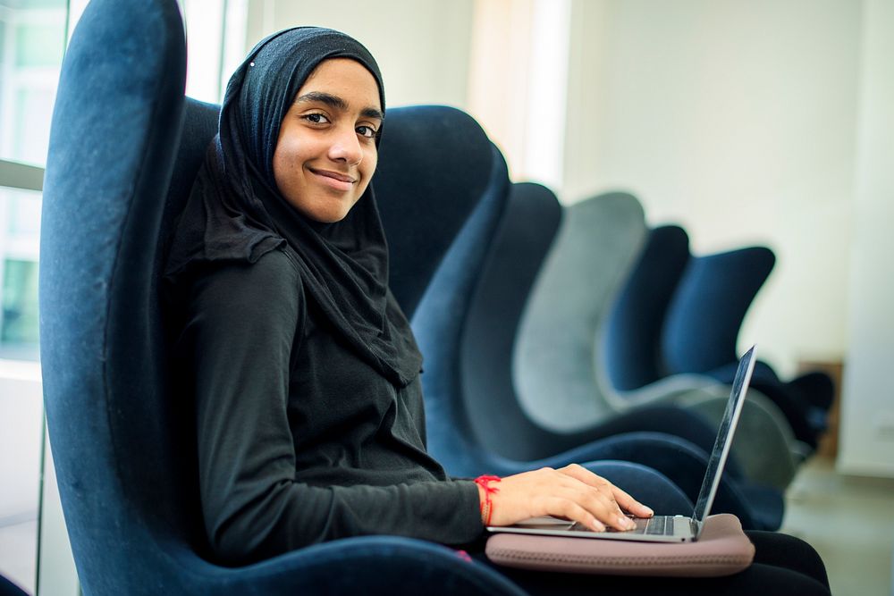Young muslim woman using computer laptop