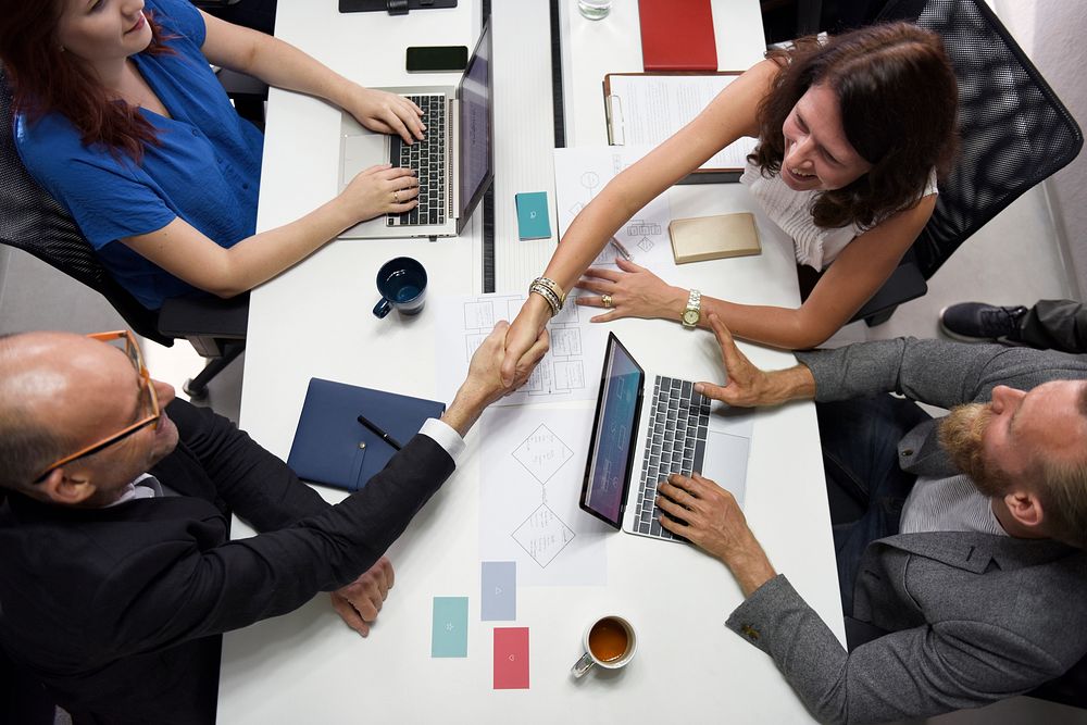 Business people shaking hands together