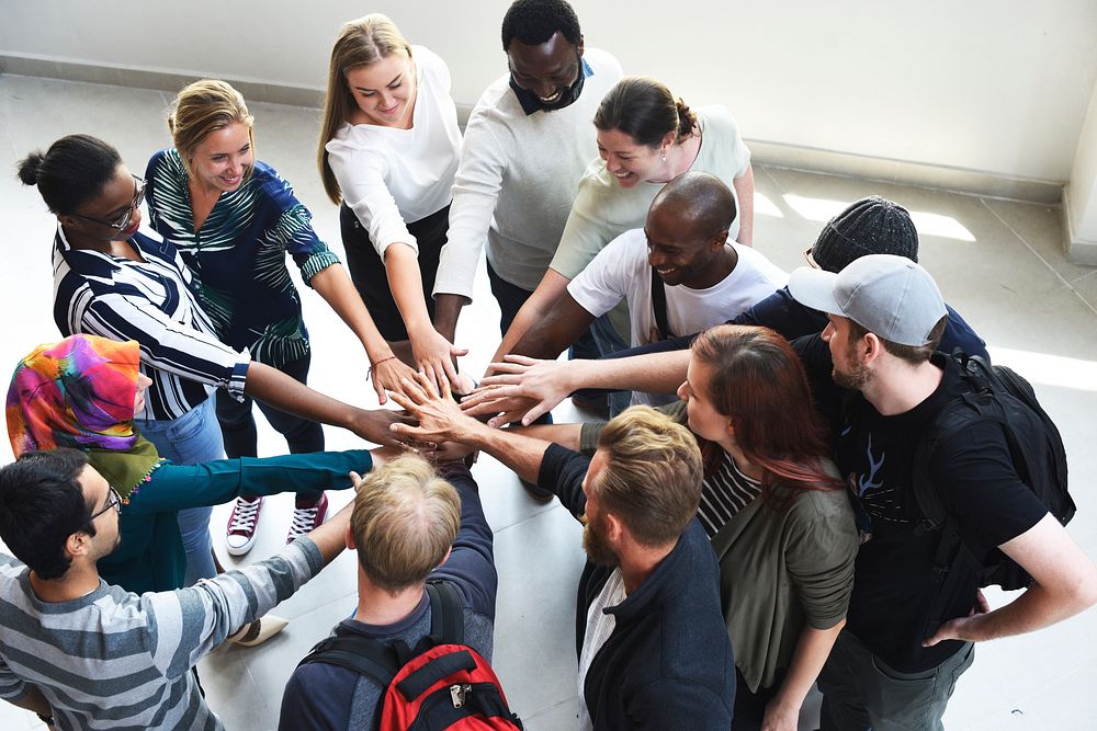 Diversity teamwork with joined hands