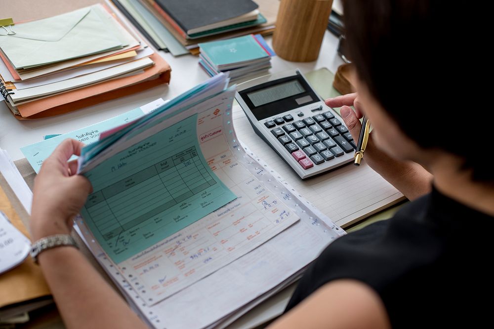 Adult asian woman working on payment bills accounting summary data