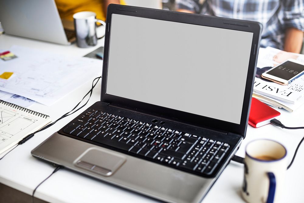 Laptop Screen Showing Blank Desktop on White Table