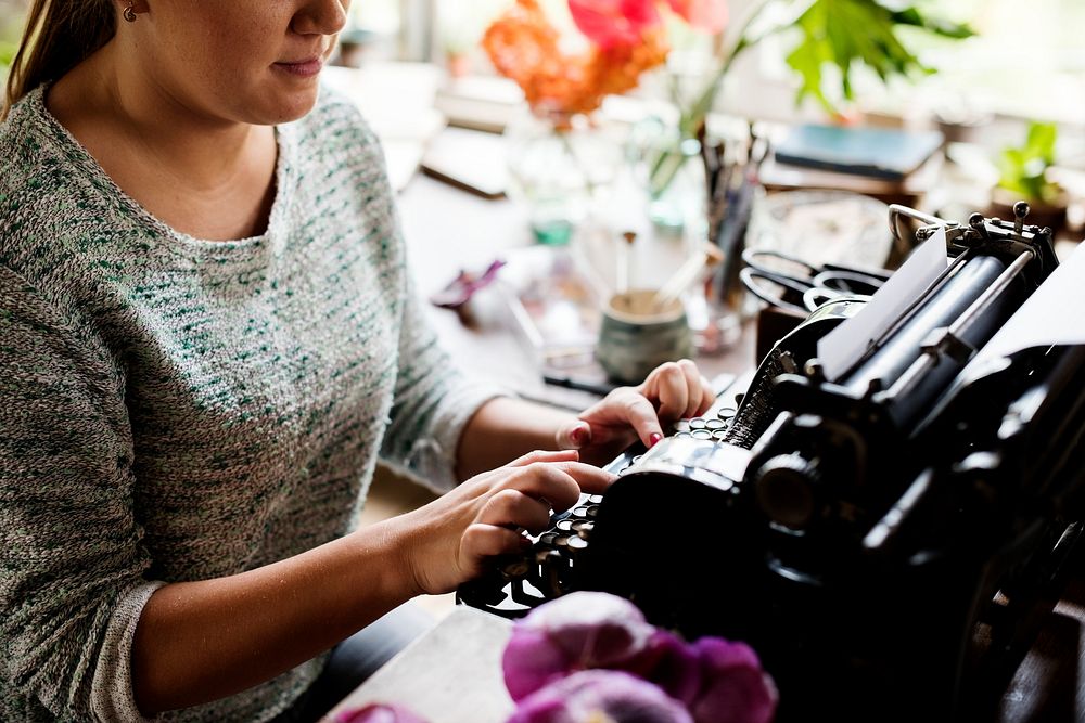 Woman typing on a vintage typewriter