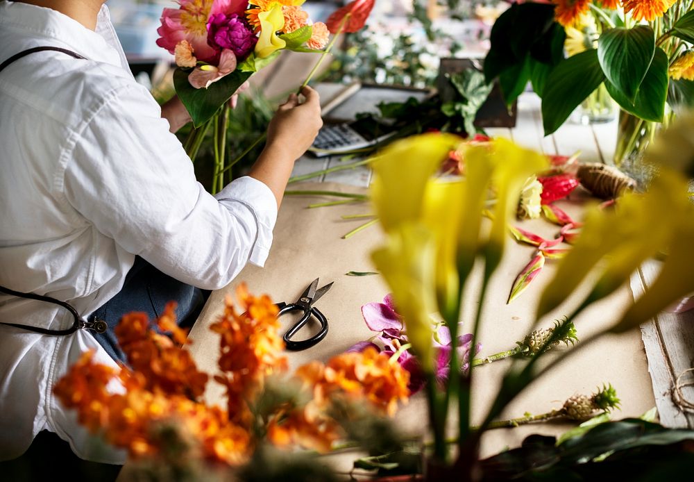 Florist making a flower arrangement in a flower shop