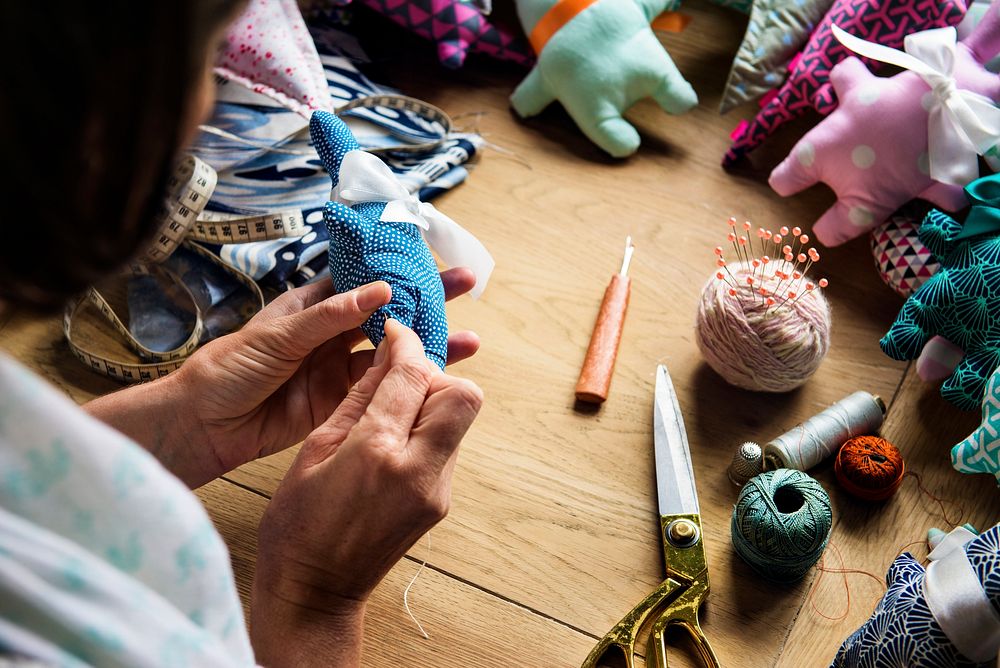 Closeup of hands sewing doll handicraft handmade