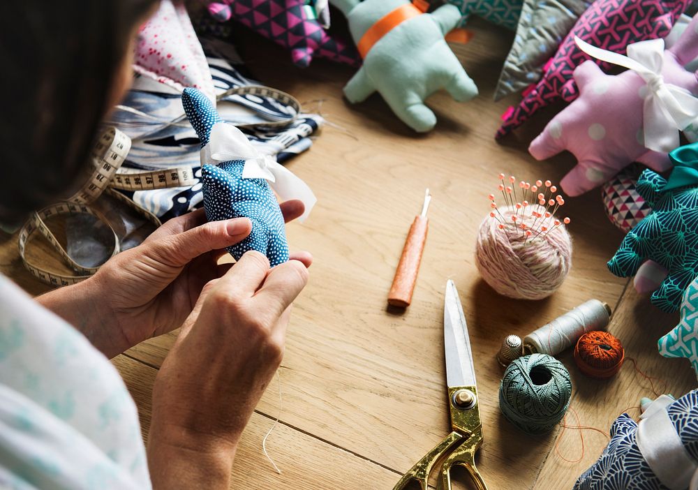 Closeup of hands sewing doll handicraft handmade